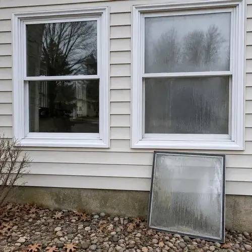 Two vinyl windows on siding