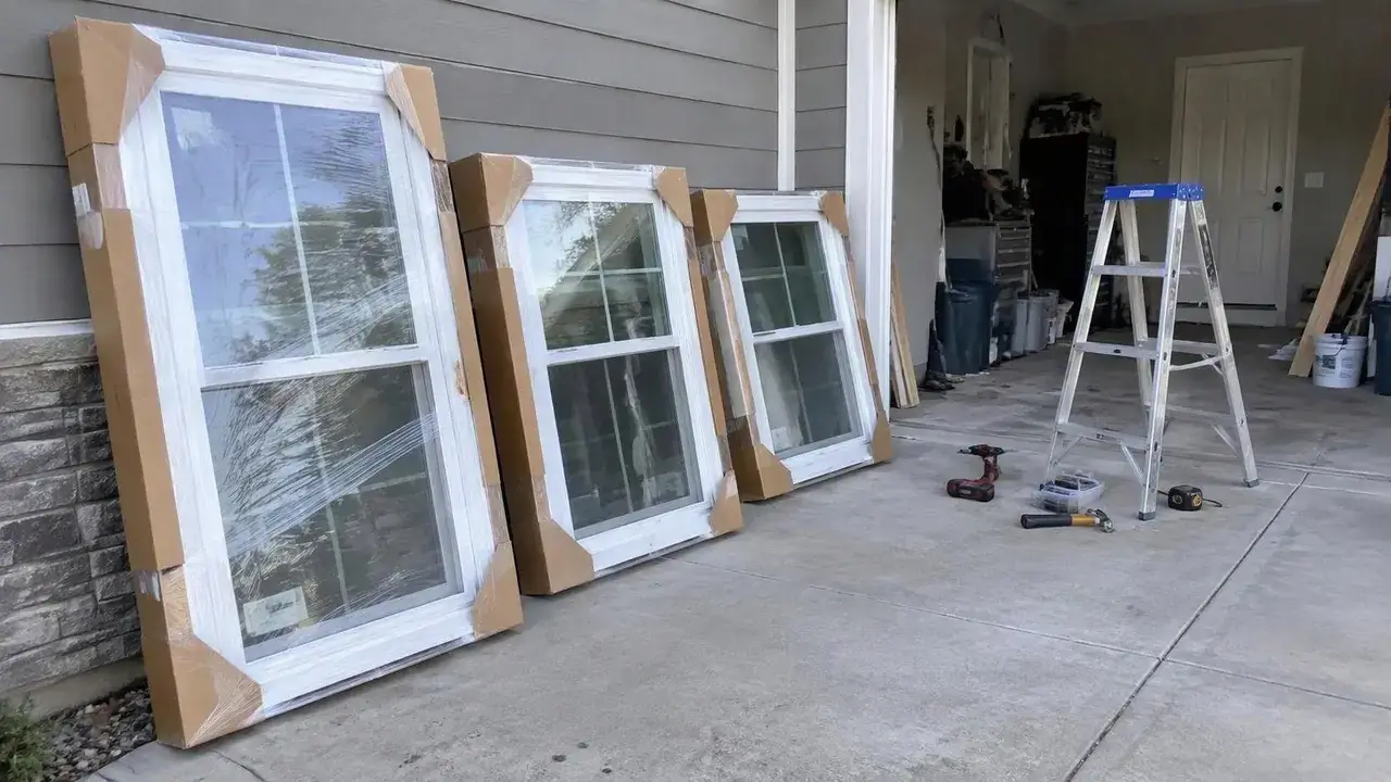 Packaged new window units waiting in a garage on site