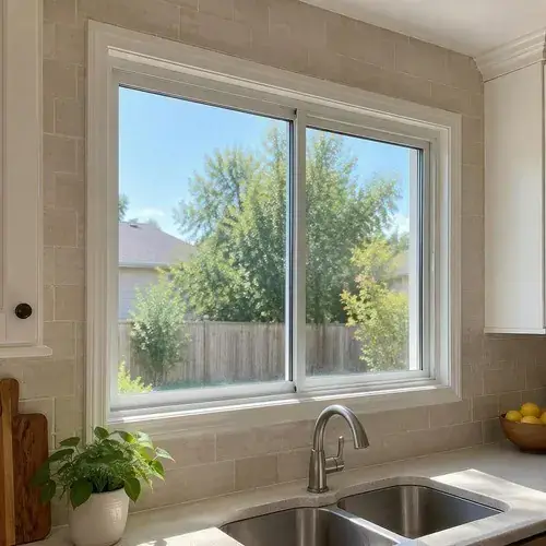 White horizontal sliding window above a kitchen sink with tiled backsplash